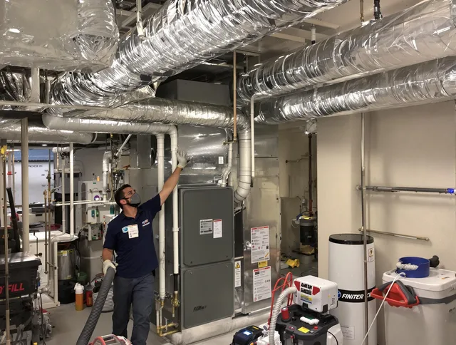 Portsmouth Air Duct Cleaning specialist performing thorough furnace duct cleaning in a Portsmouth residence