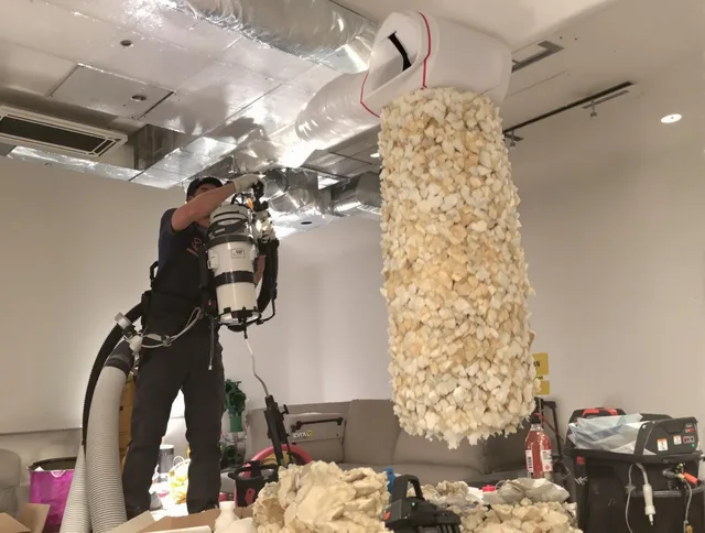 Portsmouth Air Duct Cleaning technician performing precision vacuum insulation removal in a residential property in Portsmouth
